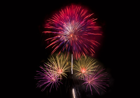 Colourful Fireworks at night over dark sky to celebrate New Year eve and special occasion on holidaysの写真素材