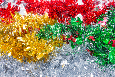 Green red gold yellow silver white mistletoe tinsels as pattern background for Christmas decorative ornament on special holiday celebration dayの写真素材