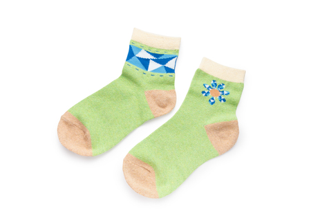 Green cute short socks with winter holiday of snowflakes paint isolated on white background (Clipping path included)の写真素材
