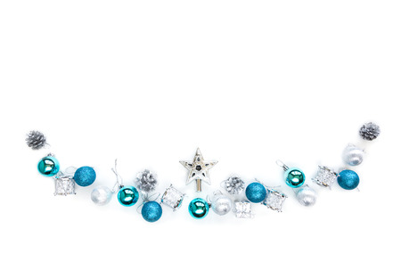 Christmas tree decorative ornaments of silver star, blue balls, pine cone, tinsels and drums over white background with copy space for winter Merry X'mas text insertion, logo or product decorationの写真素材