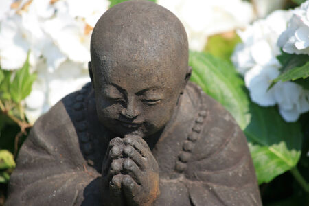 Praying buddha figurineの写真素材