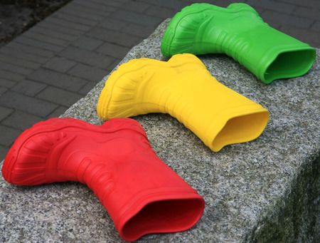 Three rubber boots in various colorsの写真素材