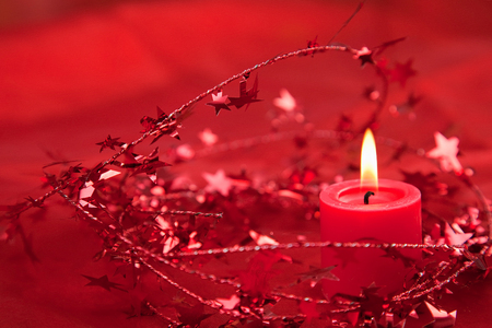 Candlelight with red Christmas decorationの写真素材