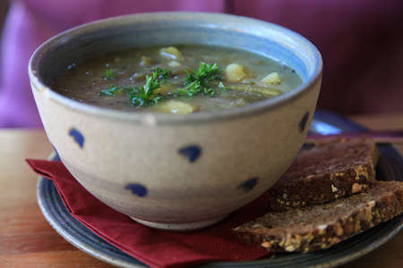 Bowl of potato soup with wholegrain breadの写真素材