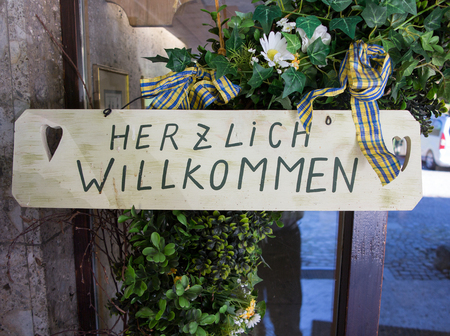 Herzlich willkommen sign translates into Welcome in Englishの写真素材
