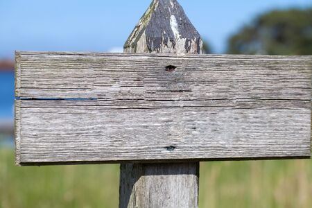 Old weathered empty wooden outdoor signpostの写真素材