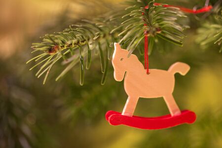 Wooden horse toy as Christmas decoration on the treeの写真素材