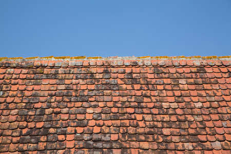 Old roof tiles against a blue sky