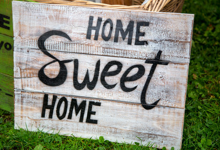 Old weathered sign with the phrase "Home sweet home"の写真素材