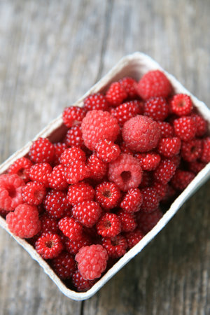 Bowl of raspberries and Japanese wineberries