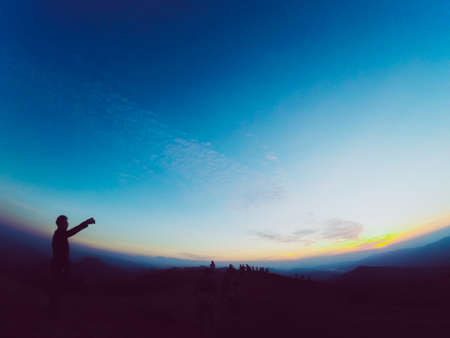 Silhouette of people with a beautiful landscape in the sunset