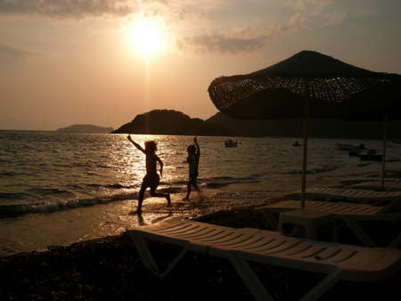 Kids are running on the beach の写真素材