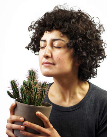 Woman smells a cactusの写真素材