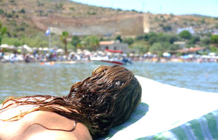 Woman is laying on beach chairの写真素材