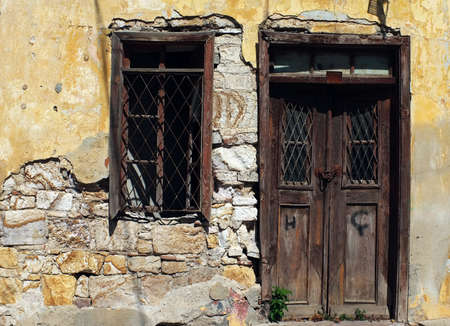 Old wooden vintage door and window in ruinの写真素材