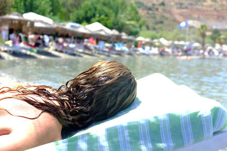 Woman is laying on beach chairの写真素材