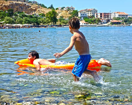 Children play in the sea