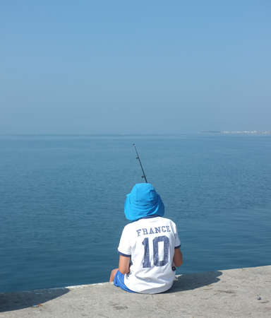 Young boy fishing with rodのeditorial素材