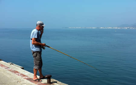 Old man fishing on pierのeditorial素材
