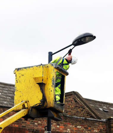 Council worker painting the street lampのeditorial素材