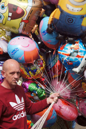 Balloon seller holding colorful balloonsのeditorial素材