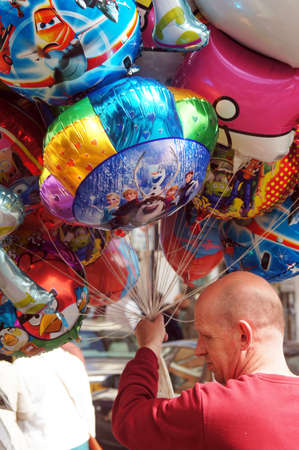 Balloon seller holding colorful balloonsのeditorial素材