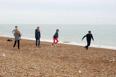Teenagers having fun on Hastings beachのeditorial素材