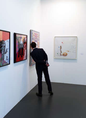 Visitor viewing artwork in Art15 trade fairのeditorial素材