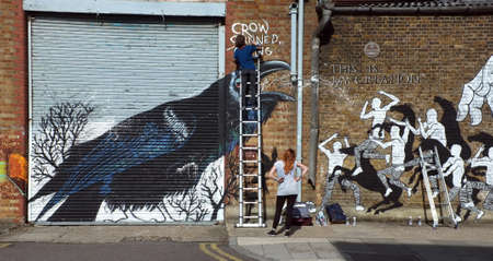 Graffiti artists paints the building wallのeditorial素材