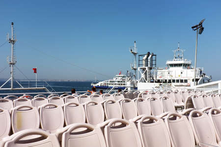Empty seats on a ferry while children looking at the sceneryのeditorial素材