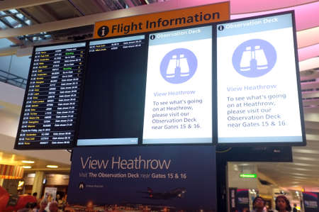Terminal 4 flight information board at Heathrow Airport in London,のeditorial素材