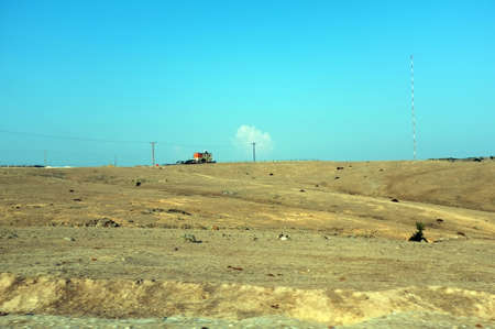 Single house at distance on a wide dry landの写真素材