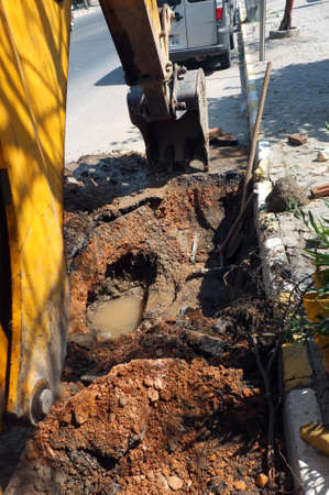 Excavator is digging a road in a cityの写真素材