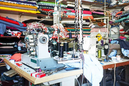 Traditional tailor workshop with sewing machines and fabricsの写真素材