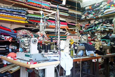 Traditional tailor workshop with sewing machines and fabricsの写真素材