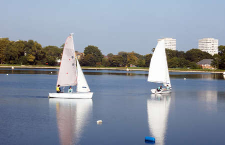 People sail on the reservoir surrounded by the buildingsのeditorial素材