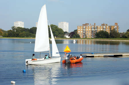People sail on the reservoir surrounded by the buildingsのeditorial素材