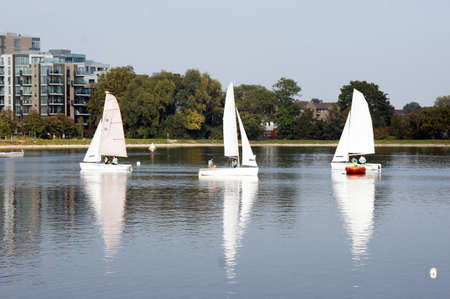 People sail on the reservoir surrounded by the buildingsのeditorial素材