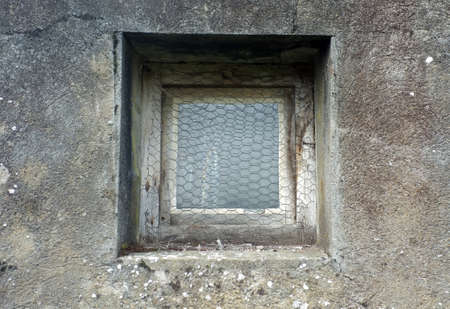 Rusty window on buildingの写真素材