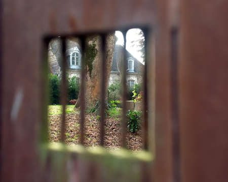 Big house through metal barsの写真素材