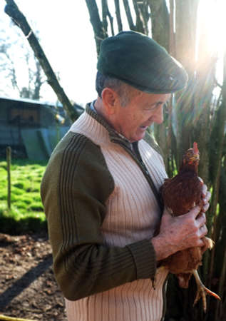 French farmer holding a chickenのeditorial素材