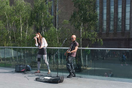 Two street musician perform on Millennium Bridge near Tate Modern in Londonのeditorial素材