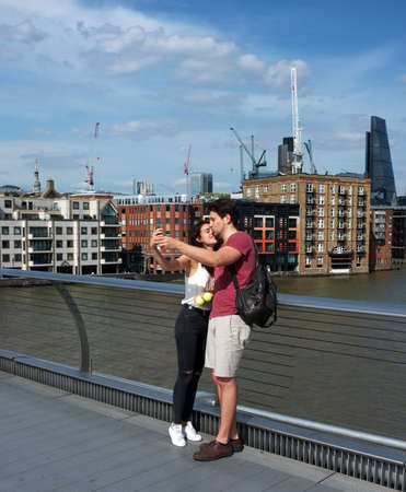 Tourist couple take selfie on the bridge in Londonのeditorial素材