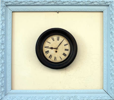 Antique wall clock in a picture frameの写真素材