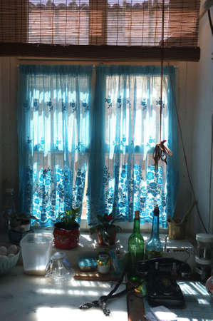 Kitchen window with blue curtainの写真素材