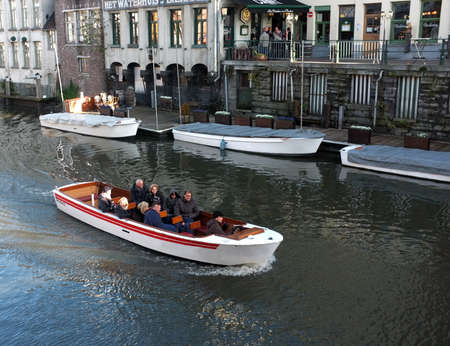 Tourists view the city on a sightseeing boat in Ghent, Belgiumのeditorial素材