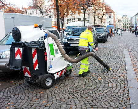 Worker cleans the street with vacuum car in Ghent, Belgiumのeditorial素材