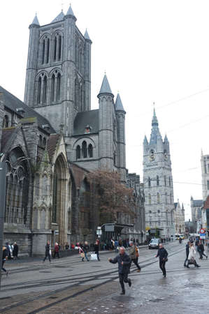 People in front of Saint Nicholas Church in the city centre of Ghent, Belgiumのeditorial素材