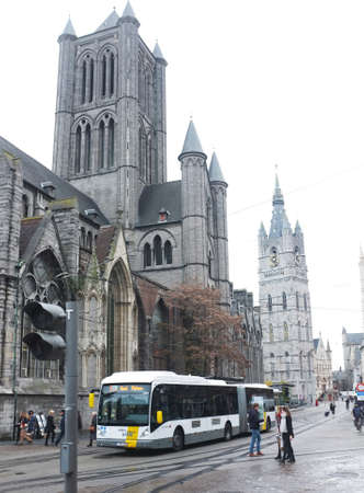 Public bus collects its passengers in front of Saint Nicholas' Church in the city centre of Ghent, Belgiumのeditorial素材