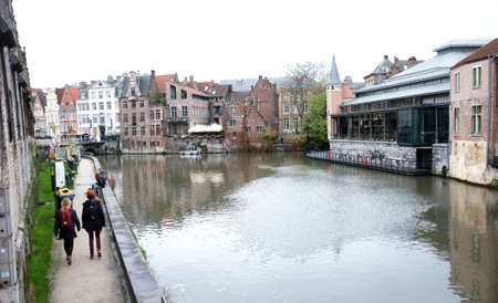 People walk by the river in the city of Ghent, Belgiumのeditorial素材
